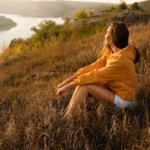side-view-woman-sitting-outdoors_52683-97520